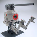 MG RB-79 Ball Ver.Ka de Bandai montado, vista frontal izquierda con brazos articulados y cañón sobre fondo uniforme.